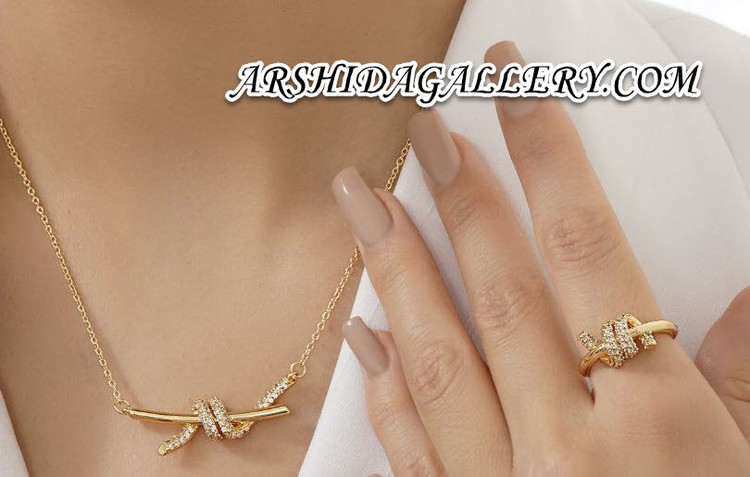 ست زنانه گردنبند انگشتر و گوشواره طرح طلای گره با آبکاری طلای 18 عیار و نگین زیرکونیا