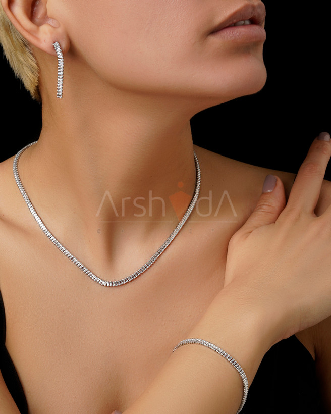 سرویس تنیسی نقرهای شامل گردنبند، دستبند و گوشواره با نگینهای باگتی زیرکونیوم درخشان بر روی مدل در آرشیدا گالری.